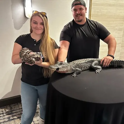 ZZ and Emily holding a python and a young alligator
